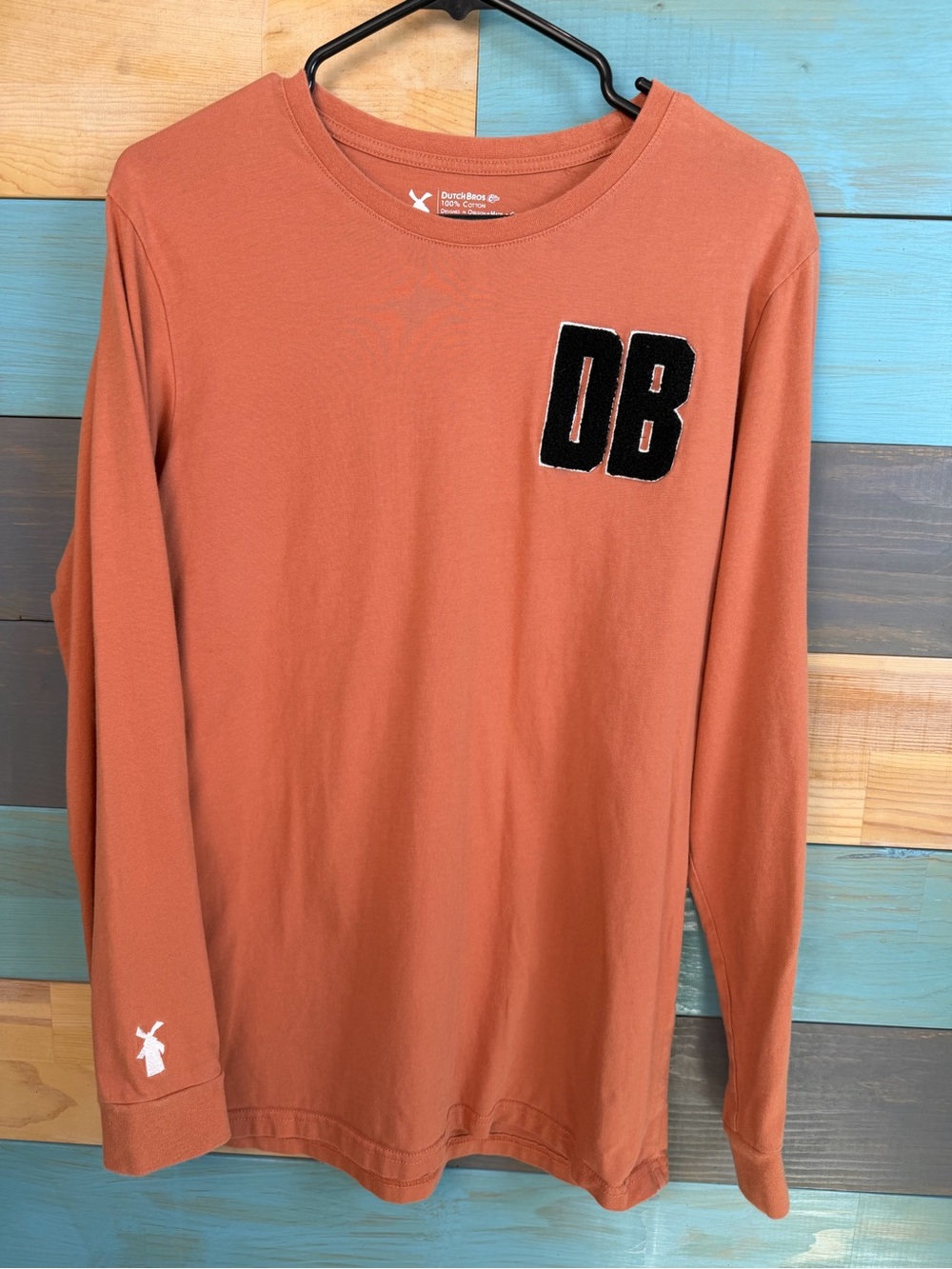 Dutch Bros Rust Orange Long Sleeve Shirt with Black DB Fuzzy Varsity Patch